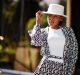 Beautiful african american woman natural makeup wear fashion clo Beautiful african american woman natural makeup wear fashion clothes casual black and white dress code office style total blouse and pants suit and hat.